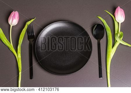 Festive Creative Black Table Setting With Tulips On Dark Background