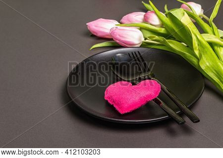 Festive Creative Black Table Setting With Tulips On Dark Background