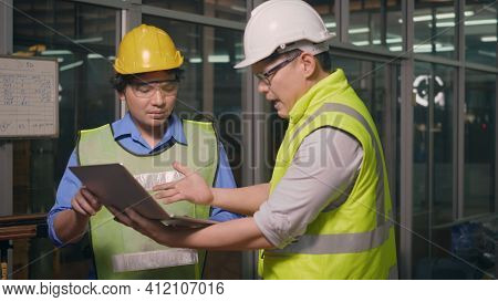 Two Factory Industrial Workers Technician Or Engineer And Manager Wear Uniforms Safety Feeling Upset