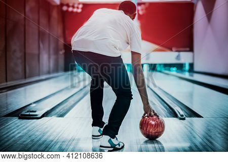 African American bowling at a hall