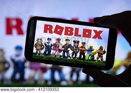 London, Uk - March 2021: Person Holding A Smartphone With Roblox Game Logo