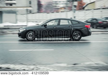 Moscow, Russia - January 29, 2021: Side View Of Black Bmw Gt 6 In Motion. Gran Turismo 630d Fast Mov