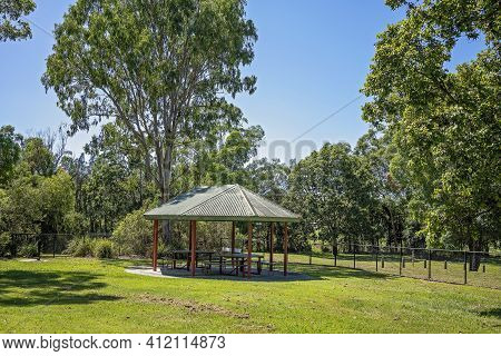 A Picnic Shade Structure With Barbecue In A Public Outdoor Park