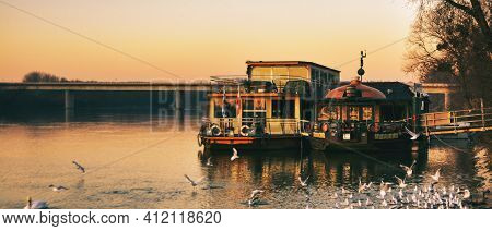 Boat On The River In Schaerding, Austria With Birds