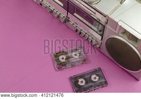 Boombox Stereo Radio Cassette Recorder And Random Cassettes On Pink Background. Vintage Cassette Dec