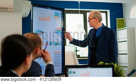 Experienced Project Leader Analysing Financial Presentation During Business Conference In Brainstorm