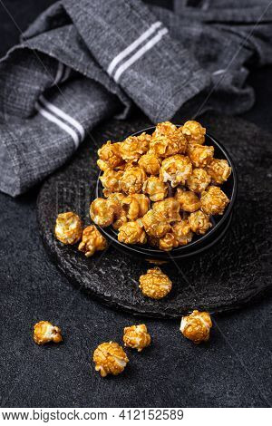 Salted Caramel Popcorn In Bowl On Dark Background