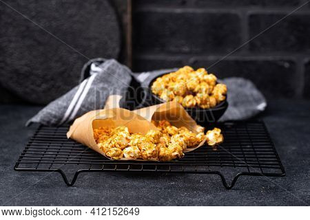 Salted Caramel Popcorn In Bowl On Dark Background