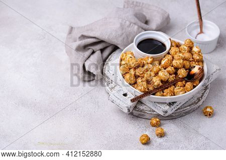 Salted Caramel Popcorn In Bowl On Light Background