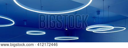 Ceiling With Round Modern Led Lamps. Suspended Fluorescent Lights Under The Ceiling. Careful Energy 