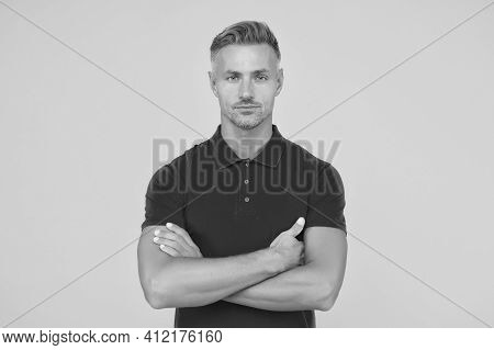 Handsome Caucasian Guy With Unshaven Face Hair Wear Red Thirt Keeping Arms Crossed Yellow Background