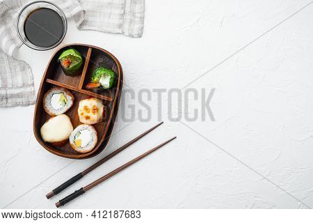 Japanese Meal In A Box Bento With Sushi Roll Eice Avocado Salmon Fish Set, On White Stone  Backgroun