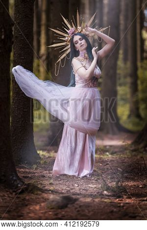 Portrait Of Sensual Crowned Caucasian Girl With Flowery Golden Crown Posing In Empty Summer Forest A