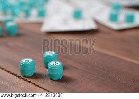 Many Barrels With Numbers And Cards For Lotto Or Russian Bingo Table Game On Wooden Surface. Russian