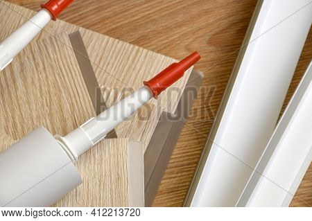 Set Of Items For Pvc Ceiling Indoor Works. Assembly Adhesive Bottles And Pvc Panels With Plastic Cor