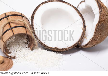 Opened Coconut Near Coconut Flakes In Wooden Bowl Isolated On White Background. Tropical, Nut. Coco.