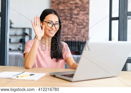 Happy Young Nice Woman Wearing Earphones, Looking At Laptop Screen, Holding Video Call Meeting Conve
