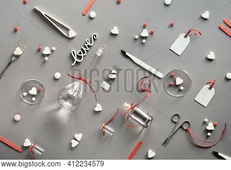 Chemistry Of Love. Creative Flat Lay On Grey Paper. Top View With Chemical Glassware, Petri Dishes, 