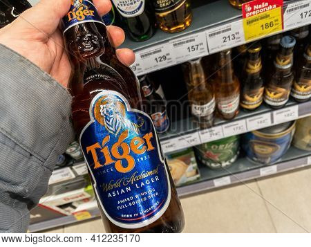 Belgrade, Serbia - March 3, 2021: Hands Holding A Bottle Of Tiger Beer. Tiger Beer Is A Brand Of Asi