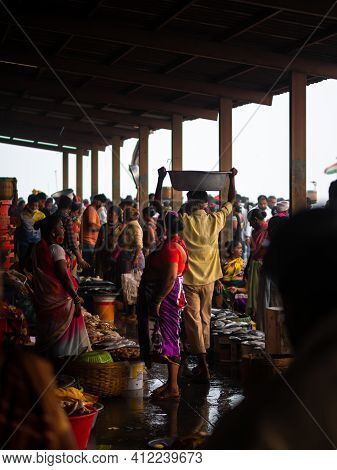 Unidentified Women And Men Trade In A Wide Variety Of Fish At One Of The Oldest Fish Market In Mumba