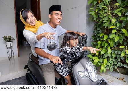 Asian Muslim Family Riding Motorbike Scooter Together Traveling With Kid