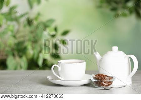 Buckwheat Tea And Granules On Table Against Blurred Background. Space For Text