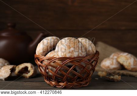 Tasty Homemade Gingerbread Cookies In Wicker Basket On Wooden Table