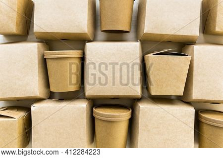 Flat Lay Of Kraft Paper Or Cardboard Eco Packages On Wooden Background