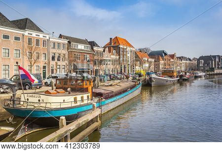 Zwolle, Netherlands - March 03, 2021: Old Ships Anf Houses At The Central Canal Of Zwolle, Netherlan
