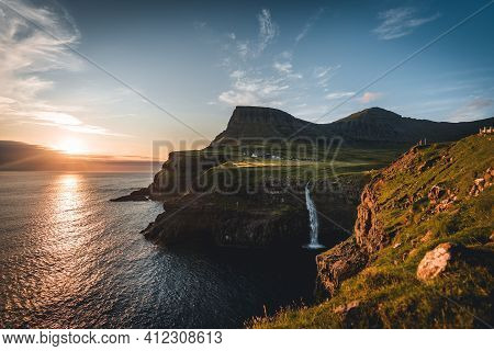 Gasadalur Village And Mulafossur Its Iconic Waterfall During Summer With Bluw Sky. Vagar, Faroe Isla