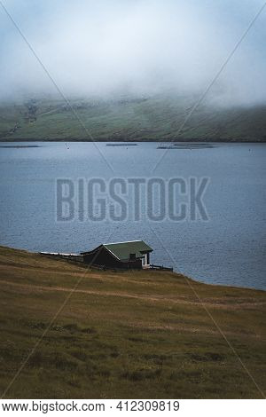 Bour Village Grass-covered Picturesque Houses At The Faroese Coastline In The Village Bour With View