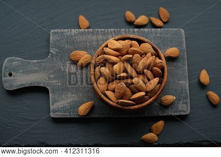 Almonds Nuts Close-up In A Cup On A Black Shabby Chic Board On A Black Schiffer Background.nuts And 