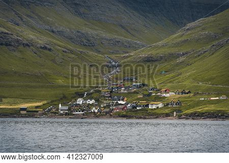 Sun Shining On Small Village On The The Northern Most Village On Stremoy In The Faroe Islands With B
