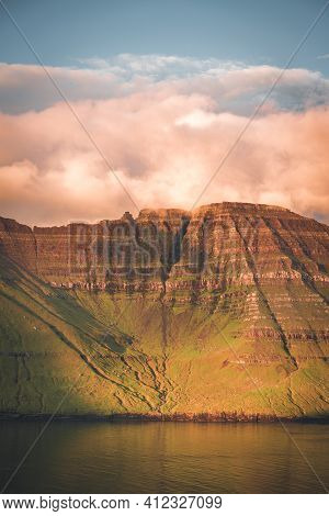 Faroe Islands Kalsoy In Sunset Light Durig Twilight With Pink Sky And Cliffs.