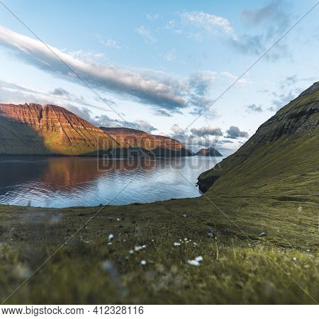 Faroe Islands Kalsoy In Sunset Light Durig Twilight With Pink Sky And Cliffs.