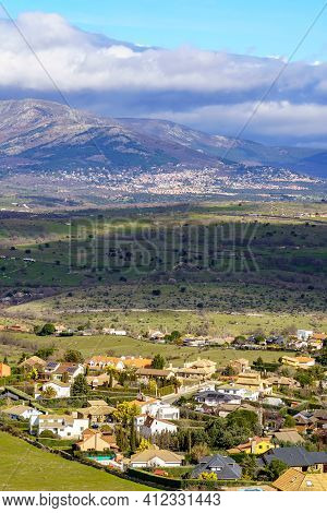 Aerial View Green Mountain Landscape With Dark Clouds And Villages With Houses On The Mountainside. 