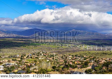 Aerial View Green Mountain Landscape With Dark Clouds And Villages With Houses On The Mountainside. 