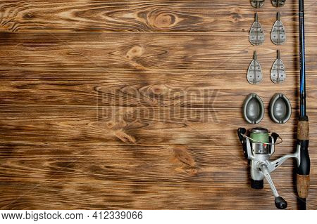 Flat Lay With Fishing Tackle, Fishing Rod And Plastic Box With Fishing Tackle And Hooks, Feeders On