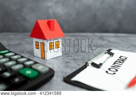 House Model With Real Estate Agent And Customer Discussing For Contract To Buy House, Insurance Or L