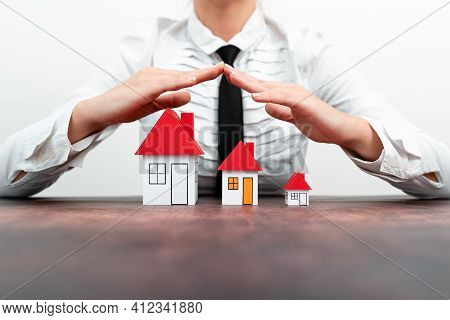 Protecting Hands Over House - Home Security And Protection Concept. Hands Holding Paper, Family Home