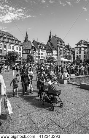 Strasbourg, France - July 29, 2017: Black And White Image Of Large Crowd Of People Pedestrians And L