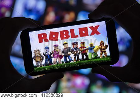 London, Uk - March 2021: Person Holding A Smartphone With Roblox Game Logo