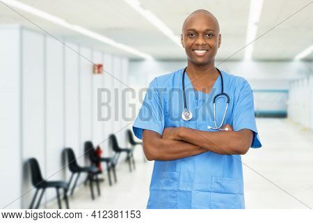 Laughing Mature Adult African American Male Nurse At Vaccination Station For Vacinating Patients Aga
