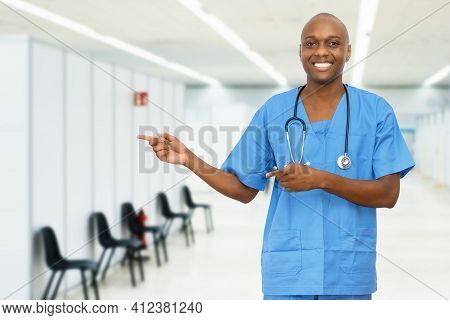Pointing Mature Adult African American Male Nurse At Vaccination Station For Vacinating Patients Aga