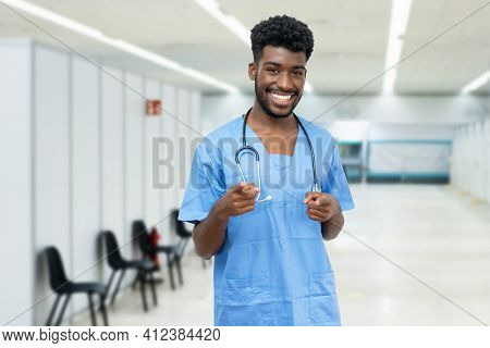 Laughing African American Male Nurse With Beard At Vaccination Station Is Ready For Vacinating Patie