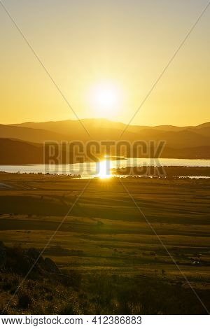 Sunset In The Mountains With Water Lake In The Valley And Sun Rays In The Blue Sky. Navacerrada Madr