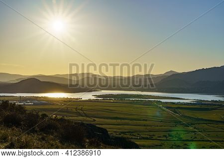 Sunset In The Mountains With Water Lake In The Valley And Sun Rays In The Blue Sky. Navacerrada Madr