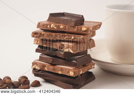 Chocolate Tower. Stack Of Chocolate Pieces. The Chunks Of Broken Chocolate. Background With Chocolat
