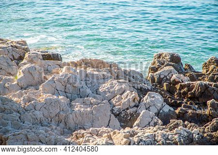 Rocky Shore Near The Blue Sea. Nature Background.