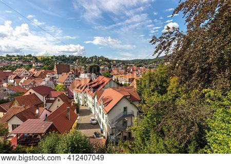 View Of The Red Roofs Of Schmalkalden, Thuringia From Above With Green Trees In The Foreground
